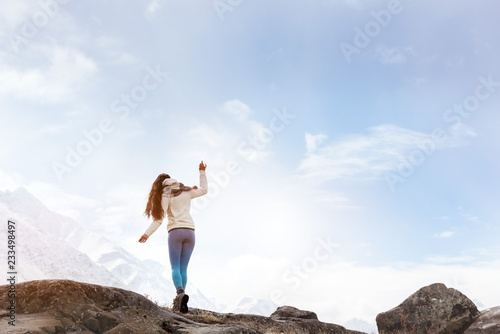 Lady walking by rock at mountains