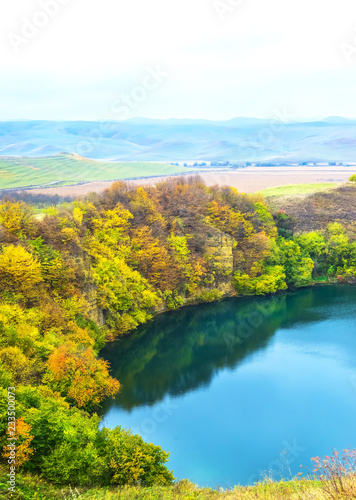 Mountain lake landscape. Reflection with autumn trees.The lake is karst origin, Shadhurey, North Caucasus, Kabardino Balkariya.  © taylon