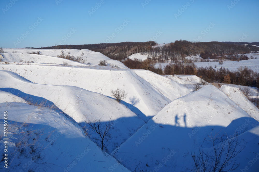 White snowy fields under a blue sky