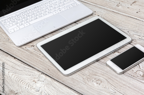 Open laptop with digital tablet on the table