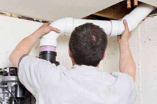 Plumber Installing PVC Pipe