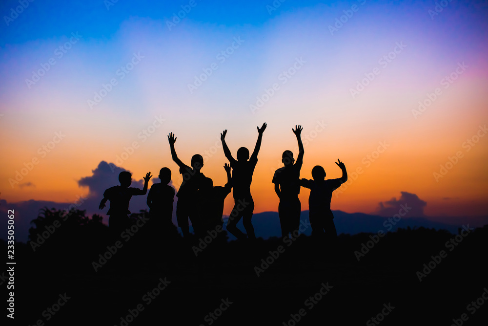 Silhouette picture style of happy jumping kids. For concept like win or success.