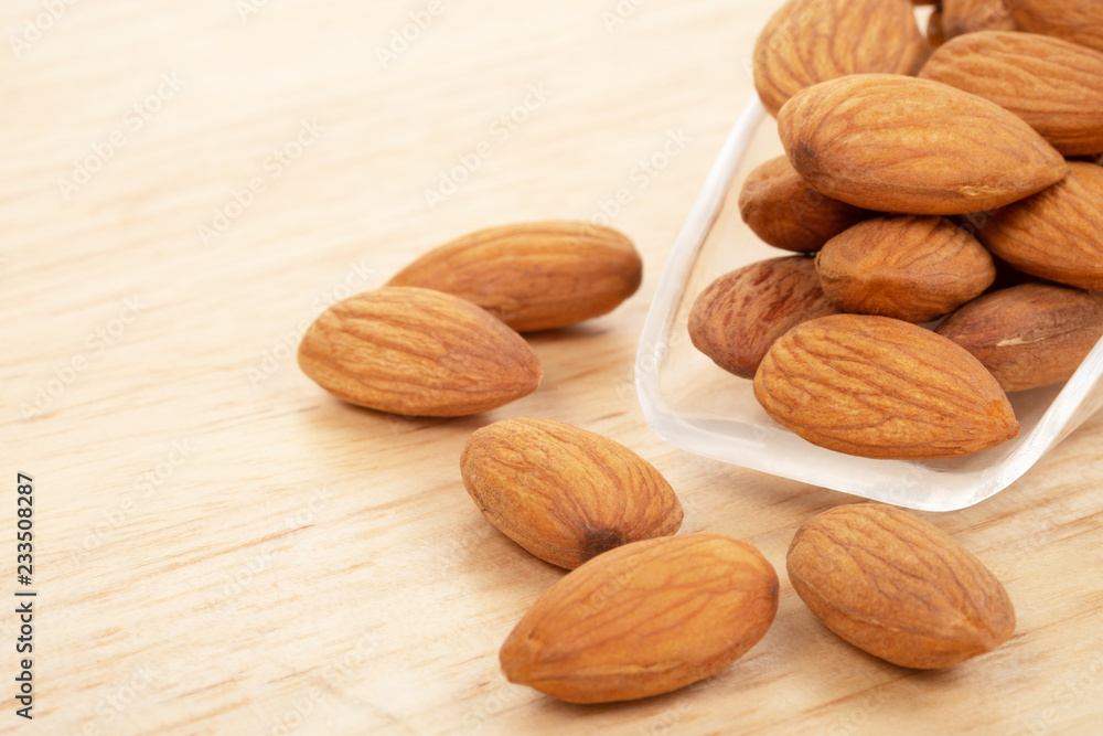 Almonds on wooden background. Healty food concept. Almonds on wooden background. Healty food concept.