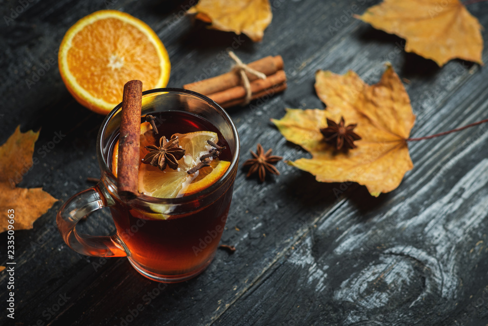 Hot mulled wine on a dark wooden table close-up Hot mulled wine on a dark wooden table close-up