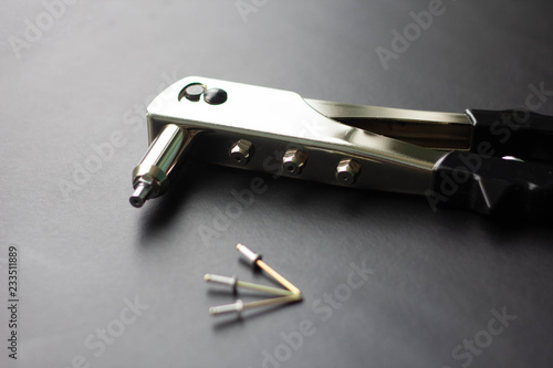 Detail of an old rivet gun (hand riveter) with rivets  photo