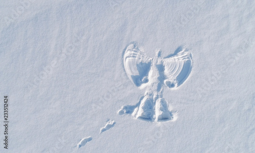 Snow angel's print on a snowcovered area. Aerial foto. photo