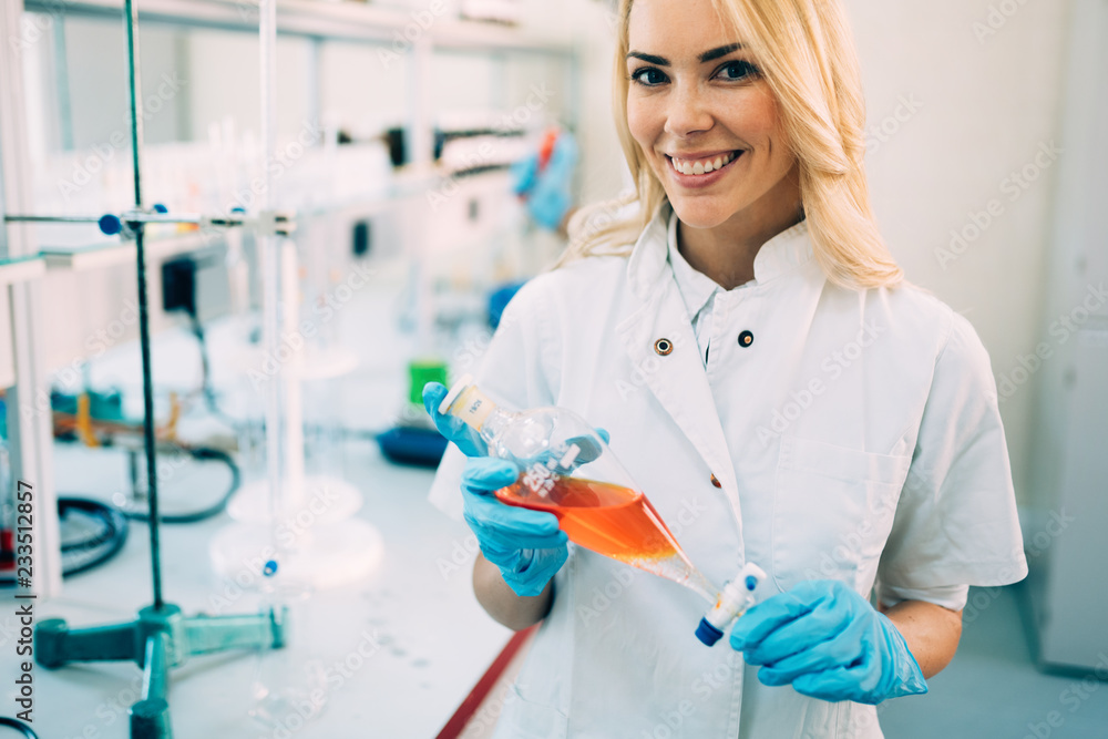 Fototapeta premium Attractive student of chemistry working in laboratory