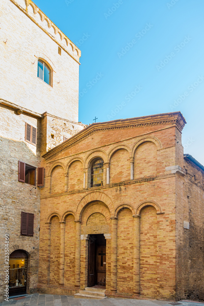 View at facade of church of San Bartolo in the streets of San Gimignano in Italy