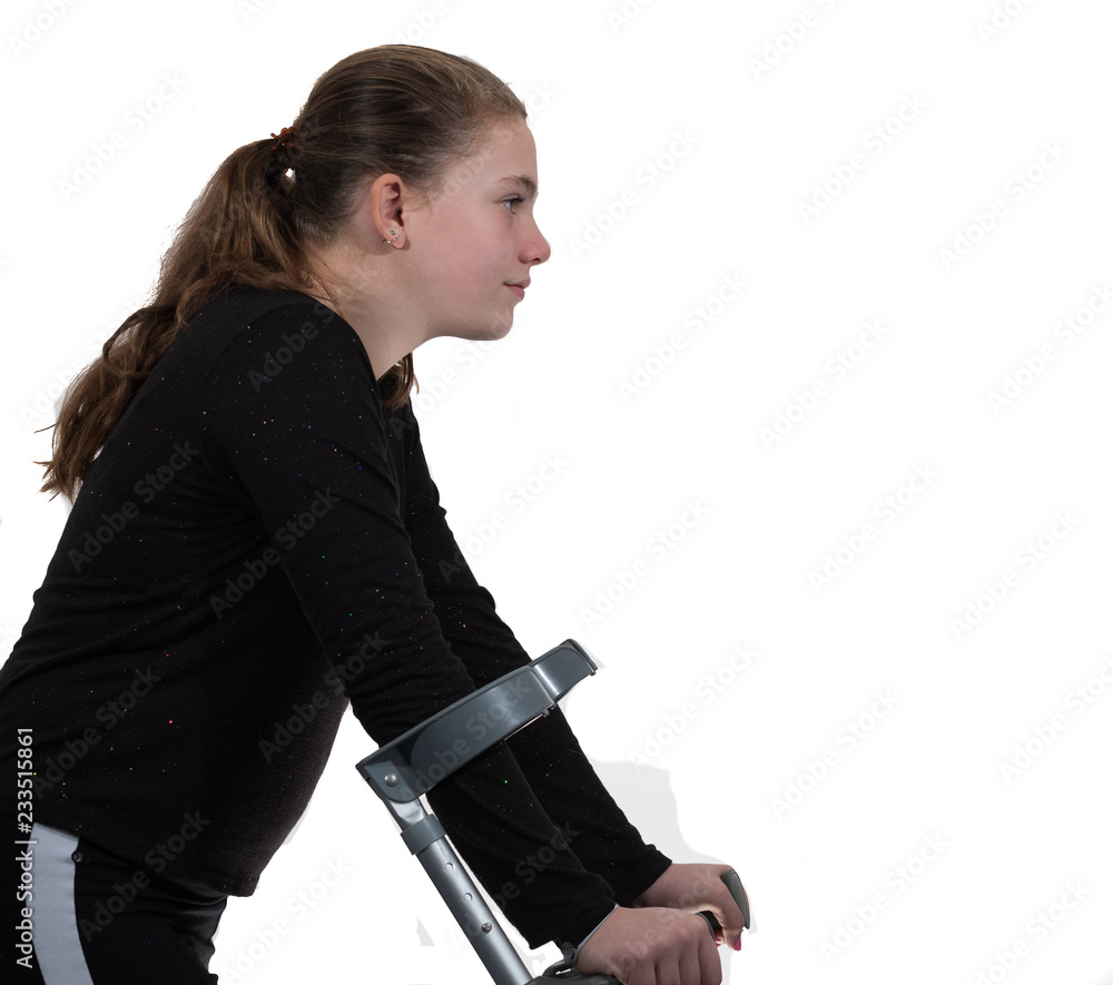 A young handicapped girl walking with crutches. A young handicapped girl walking with crutches.
