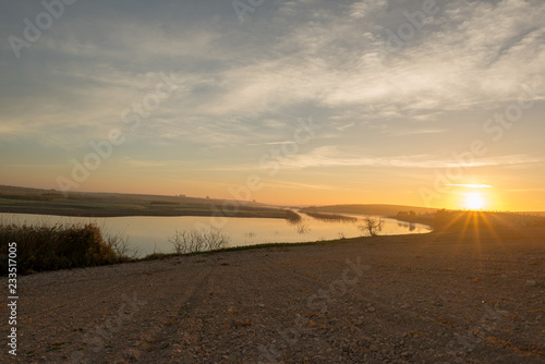The sun at dawn by the Guadiana river