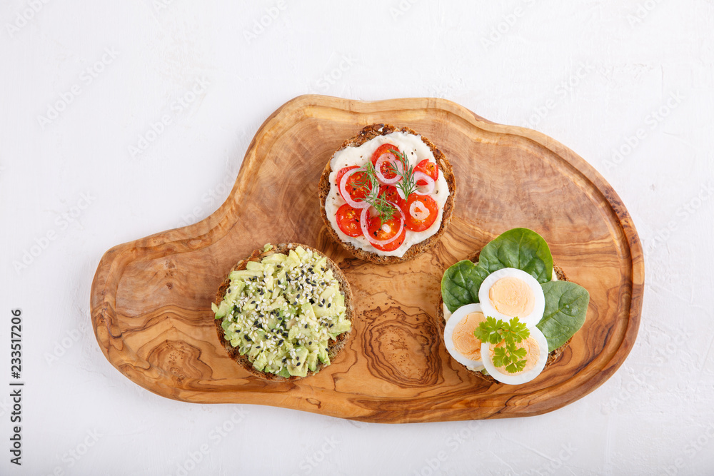 Different kinds of whole grain bread sandwiches on white background. Different kinds of whole grain bread sandwiches on white background.