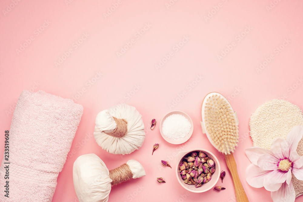 Feminine beauty and spa products, tools and cosmetics over the pink background