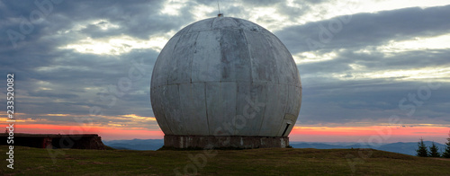 The old military facility is a tracking system. Radar base. Old giant dome of a radar antenna of a Ukrainian military base. Apocalyptic view. photo