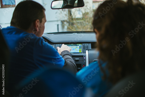 Couple in the car getting ready to travel checking the navigation  © Emiliya
