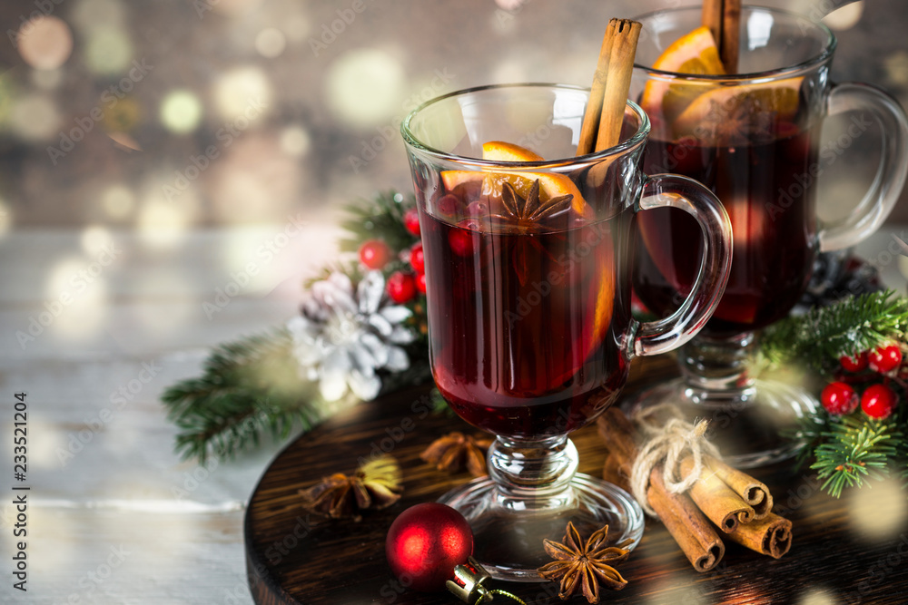 Mulled wine in glass mug with fruit and spices. Mulled wine in glass mug with fruit and spices.