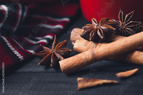 Anise star spices and cinnamon sticks on dark rystic wooden background photo