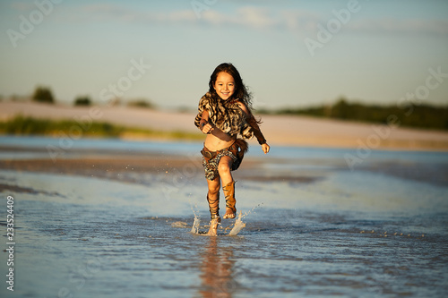 Girl runs along the shore