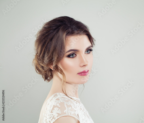 Young beautiful woman face closeup portrait. Perfect makeup, bridal hair