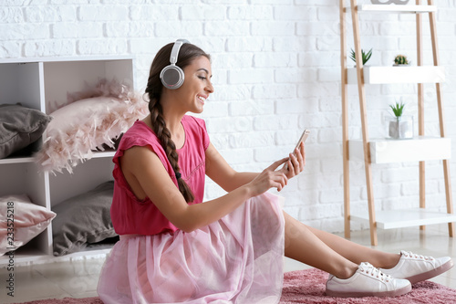 Beautiful woman listening t...