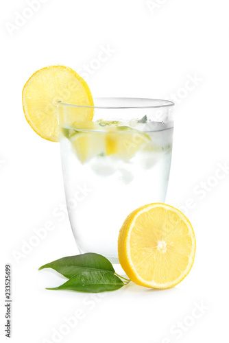 Glass of cool lemon water on white background