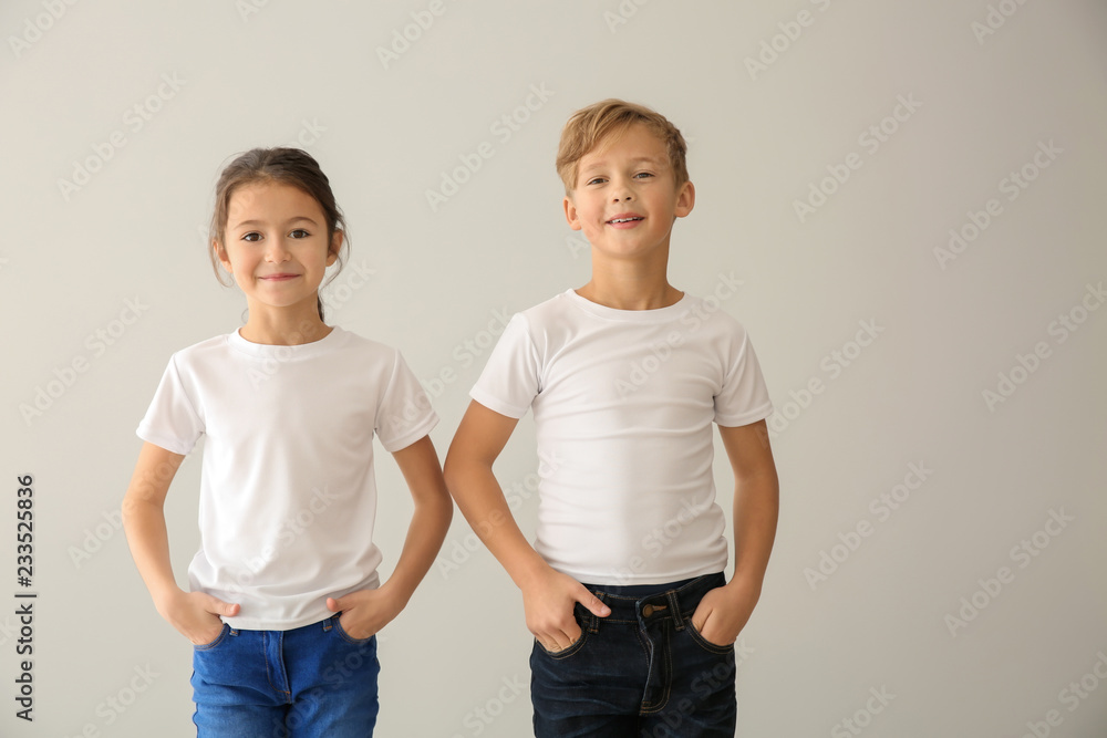 Cute children in t-shirts on light background Cute children in t-shirts on light background