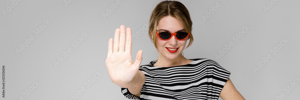 Young girl with glasses shows a hand sign stop. Young girl with glasses shows a hand sign stop.