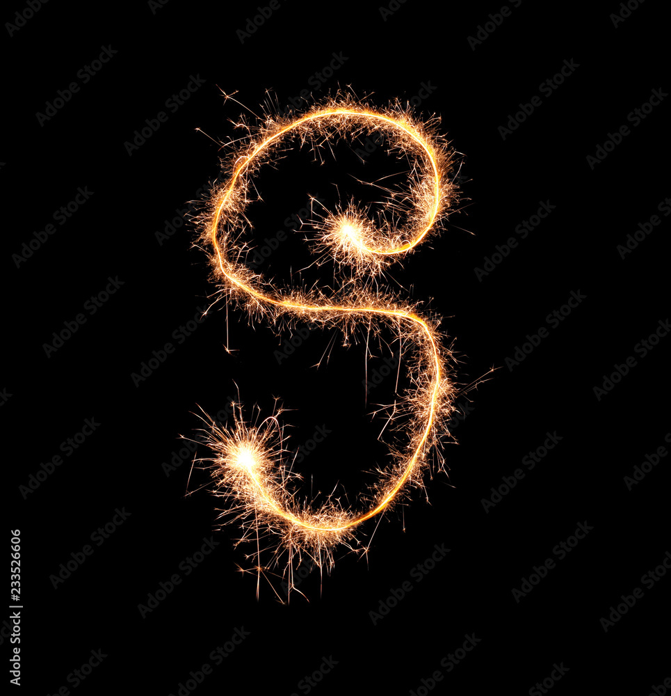 Sparklers forming letter S on dark background Sparklers forming letter S on dark background