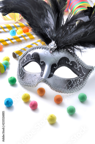 carnival mask among colorful cotillon on white background