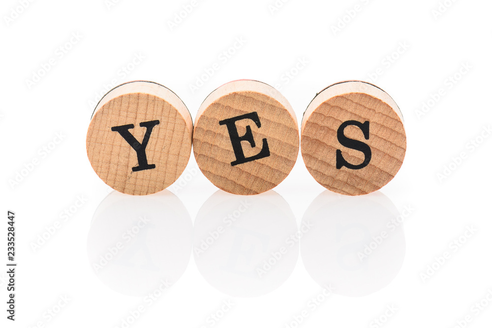 Word Yes from circular wooden tiles with letters children toy. Word Yes from circular wooden tiles with letters children toy.