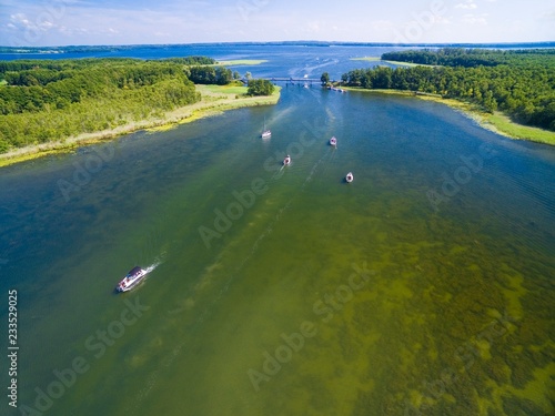 Aerial view of yachts sailing on Kirsajty Lake, Dargin Lake in the distance, Mazury, Poland photo