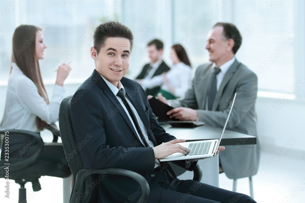 Portrait of handsome young business man and laptop Portrait of handsome young business man and laptop