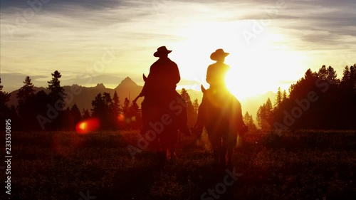 Silhouette of Cowboy Riders forest wilderness area Canada photo