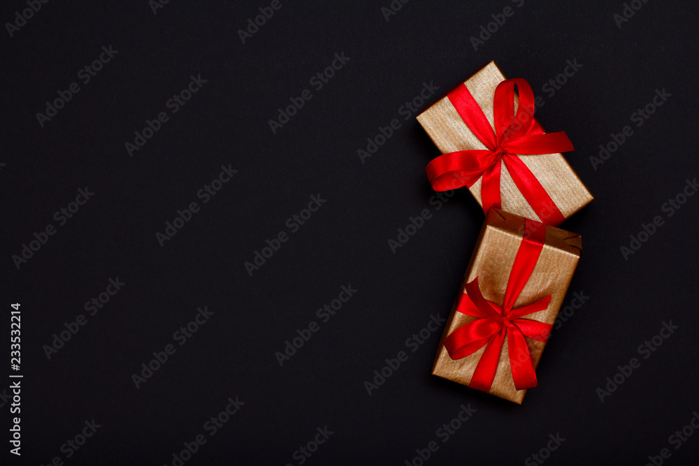 Gift boxes with red ribbons on black background. Gift boxes with red ribbons on black background.