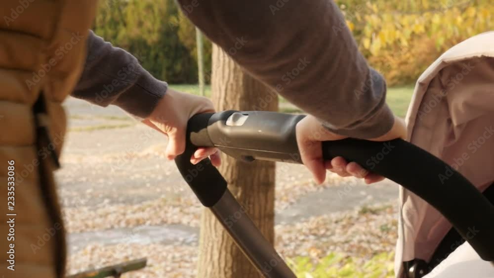 Modern stroller handle in mother hands slow motion footage Modern stroller handle in mother hands slow motion footage