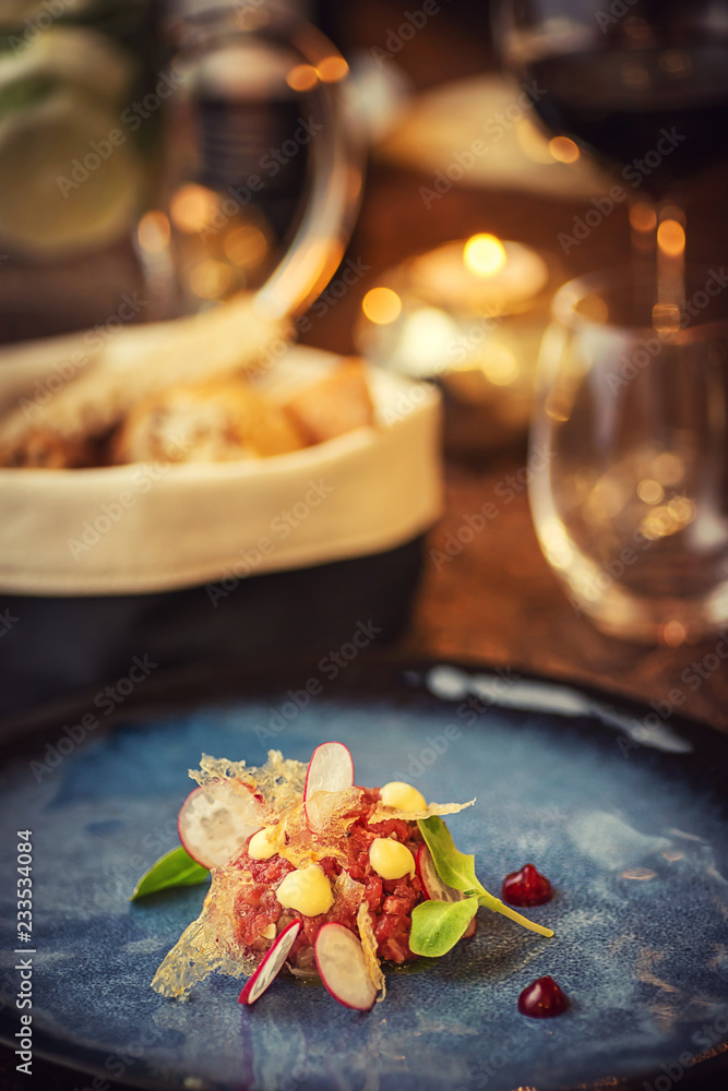Tartare steak with a glass of wine and hornets, product photography for the restaurant, modern gastronomy Tartare steak with a glass of wine and hornets, product photography for the restaurant, modern gastronomy