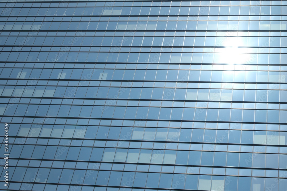 Glas facade of a business building with reflecting sun in Ginza district, Tokyo, Japan Glas facade of a business building with reflecting sun in Ginza district, Tokyo, Japan