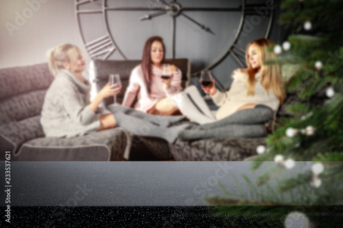 Table background of free space and three girls on sofa 