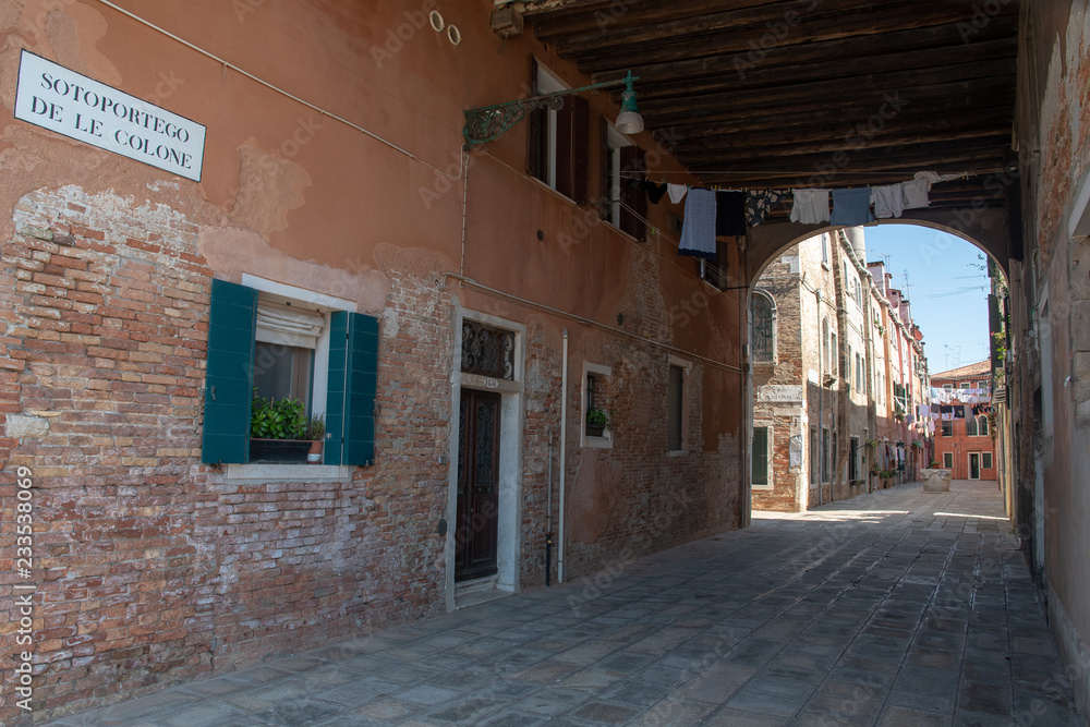 Street view with ancient buildings and porch, Venice, Veneto, Italy