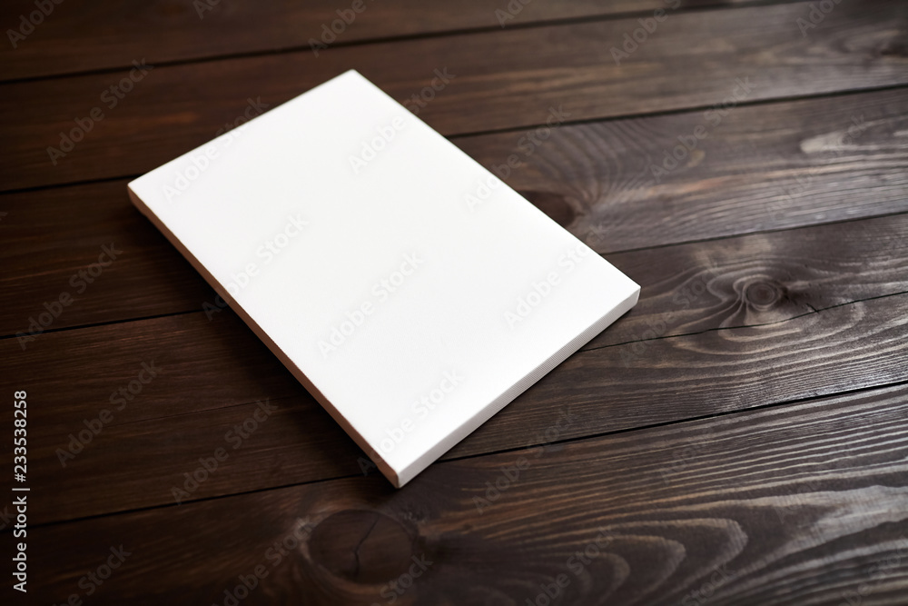 White blank canvas on brown wooden background. Mockup White blank canvas on brown wooden background. Mockup