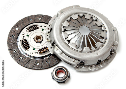 Set of replacement automotive clutch isolated on white background. Disc and clutch basket with release bearing.
