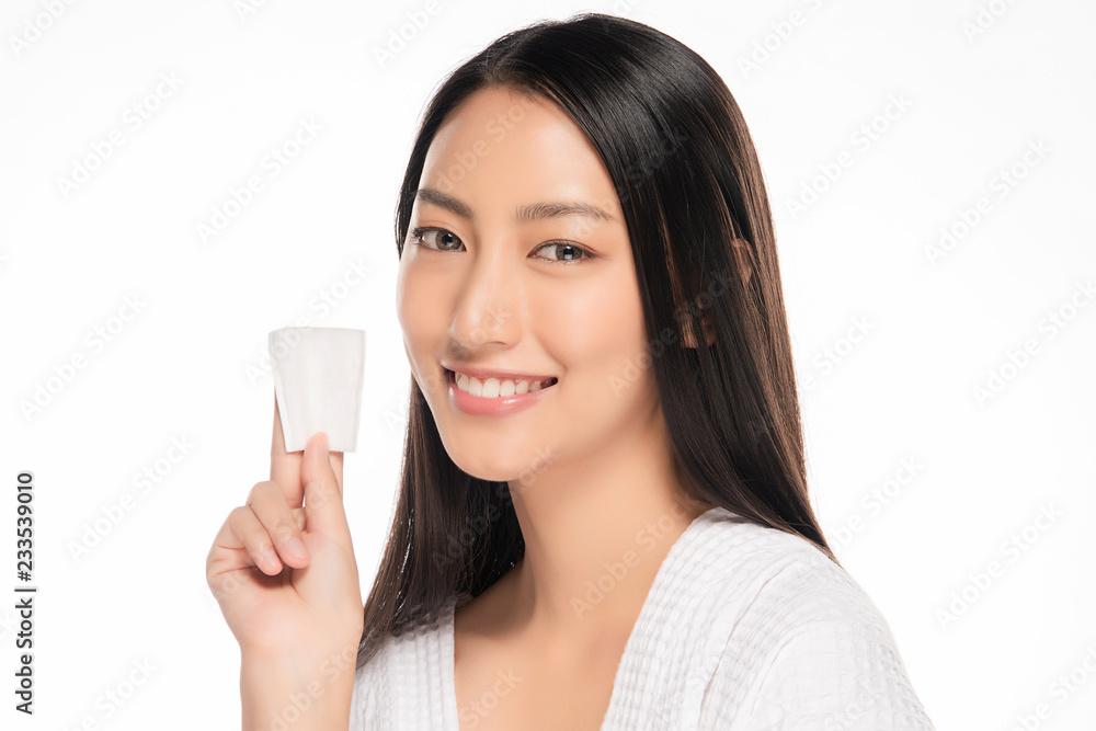 Beautiful women clean face with cotton on white background Beautiful women clean face with cotton on white background