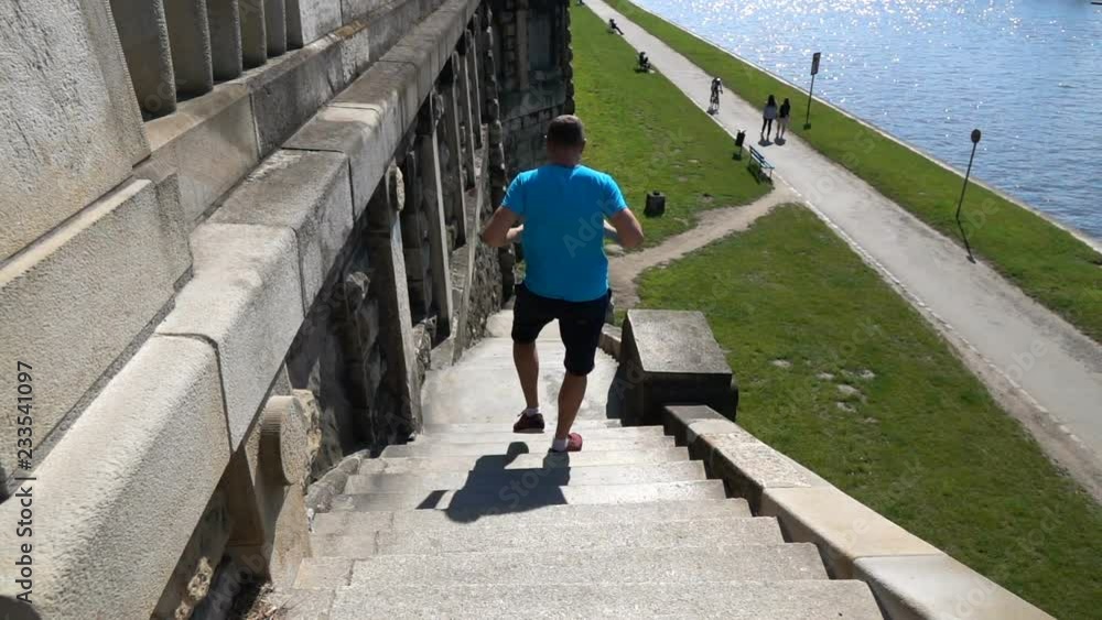 Young man jogging on stairs in the city, super slow motion Young man jogging on stairs in the city, super slow motion
