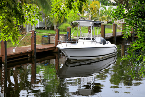 Close up parked boat at dock on canal in Florida, USA
