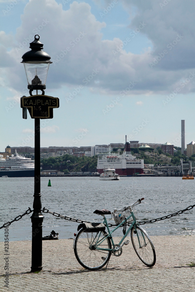 Bicycle next to lamp post at the port of Stockholm, Sweden