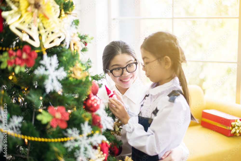 Sister make a christmas gift box to younger sister for xmas holiday,Happy and smiling together Sister make a christmas gift box to younger sister for xmas holiday,Happy and smiling together
