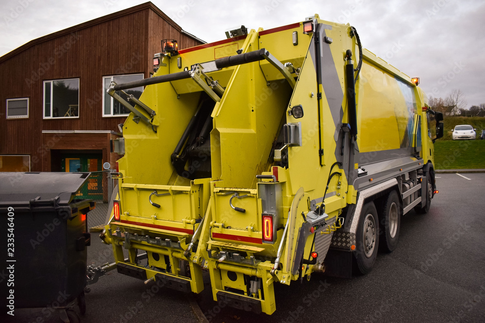 Loading garbage in the garbage truck. Garbage removal. Work garbage