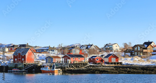 Winter and snow - Red fishing pier and fishing boats in Salhus strait in Brnnoy municipality, Northern Norway 