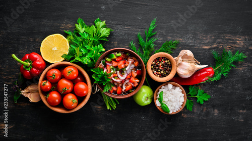 salsa sauce and ingredients. Latin American Mexican Traditional Sauce. Top view. On a black background. Free space for text.