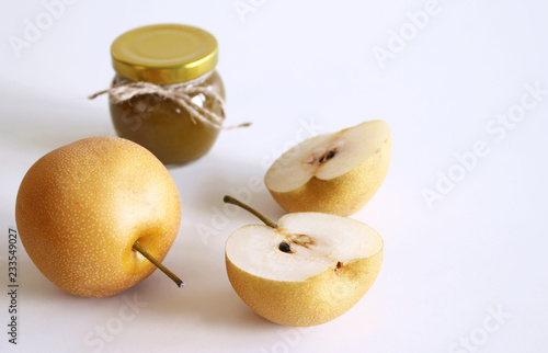 Jar of nashi jam on white wooden background . Delicious fruit . Blurred background,food and healthy concept.