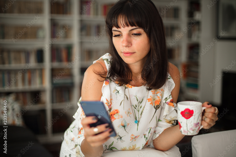 Attractive young woman using a brand new smartphone